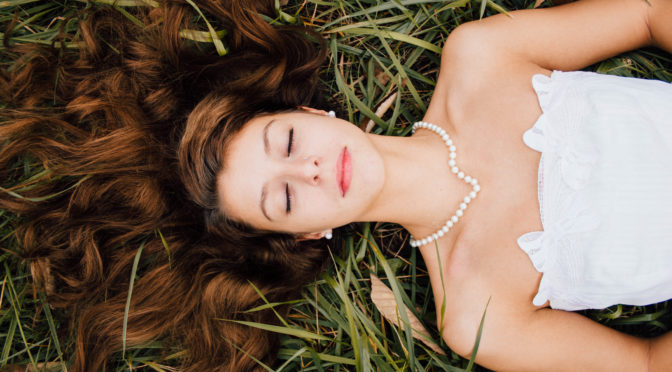 woman in white dress wearing pearls